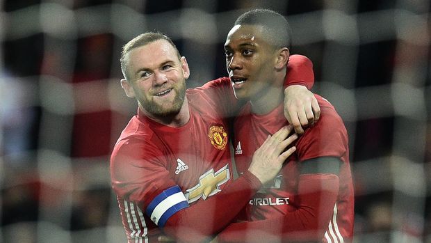 Manchester United's French striker Anthony Martial (R) celebrates scoring his team's third goal with Manchester United's English striker Wayne Rooney during the EFL (English Football League) Cup quarter-final football match between Manchester United and West Ham United at Old Trafford in Manchester, north west England, on November 30, 2016. / AFP / Oli SCARFF / RESTRICTED TO EDITORIAL USE. No use with unauthorized audio, video, data, fixture lists, club/league logos or 'live' services. Online in-match use limited to 75 images, no video emulation. No use in betting, games or single club/league/player publications.  /         (Photo credit should read OLI SCARFF/AFP via Getty Images)