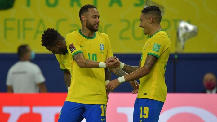 Brazils Raphinha (R) celebrates with Brazils Neymar after scoring against Uruguay during the South American qualification football match for the FIFA World Cup Qatar 2022, in Arena Amazonia, Manaus, Brazil, on October 14, 2021. (Photo by NELSON ALMEIDA / AFP) (Photo by NELSON ALMEIDA/AFP via Getty Images)