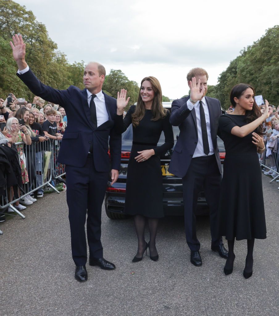 WINDSOR, ENGLAND - SEPTEMBER 10: Prince Harry, Duke of Sussex, Meghan, Duchess of Sussex, Prince William, Prince of Wales and Catherine, Princess of Wales look at floral tributes laid by members of the public on the Long walk at Windsor Castle on September 10, 2022 in Windsor, England. Crowds have gathered and tributes left at the gates of Windsor Castle to Queen Elizabeth II, who died at Balmoral Castle on 8 September, 2022. (Photo by Chris Jackson - WPA Pool/Getty Images)