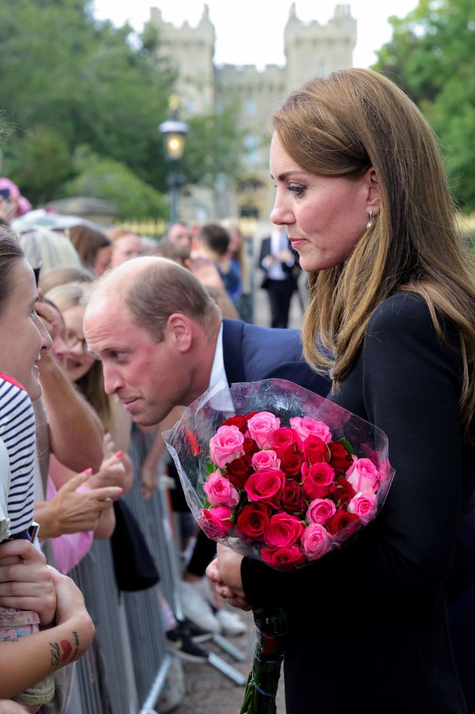 WINDSOR, ENGLAND - SEPTEMBER 10: Prince William, Prince of Wales and Catherine, Princess of Wales speak with members of the public on the Long walk at Windsor Castle on September 10, 2022 in Windsor, England. Crowds have gathered and tributes left at the gates of Windsor Castle to Queen Elizabeth II, who died at Balmoral Castle on 8 September, 2022. (Photo by Chris Jackson - WPA Pool/Getty Images)
