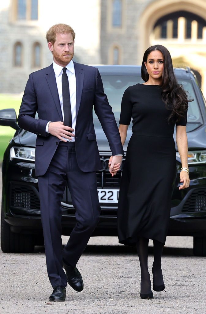 WINDSOR, ENGLAND - SEPTEMBER 10: Prince Harry, Duke of Sussex, and Meghan, Duchess of Sussex arrive on the long Walk at Windsor Castle arrive to view flowers and tributes to HM Queen Elizabeth on September 10, 2022 in Windsor, England. Crowds have gathered and tributes left at the gates of Windsor Castle to Queen Elizabeth II, who died at Balmoral Castle on 8 September, 2022. (Photo by Chris Jackson/Getty Images)