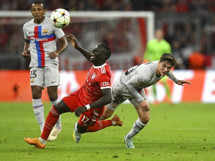 Bayern Munich Bungkam Barcelona, Lewandowski Tak Berkutik Barcelona's Robert Lewandowski, left, challenges for the ball with Bayern's Marcel Sabitzer during the Champions League, group C soccer match between Bayern Munich and Barcelona at the Allianz Arena in Munich, Germany, Tuesday, Sept. 13, 2022. (AP Photo/Andreas Schaad)