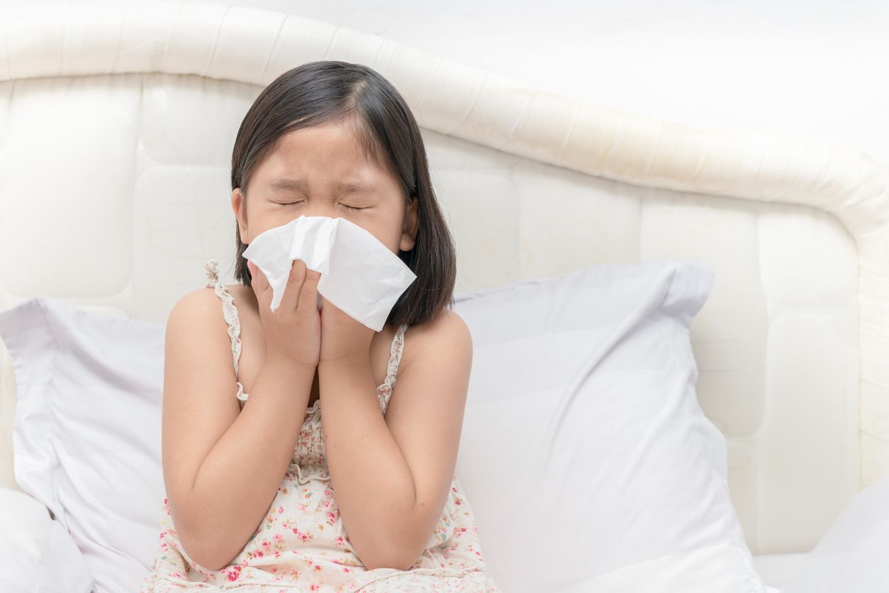 Asian girl blowing the nose by tissue, health care and sick concept