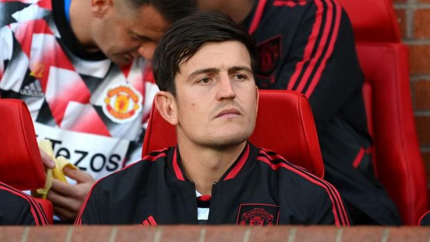 MANCHESTER, ENGLAND - AUGUST 22: Harry Maguire of Manchester United looks on from the substitutes bench prior to the Premier League match between Manchester United and Liverpool FC at Old Trafford on August 22, 2022 in Manchester, England. (Photo by Michael Regan/Getty Images)
