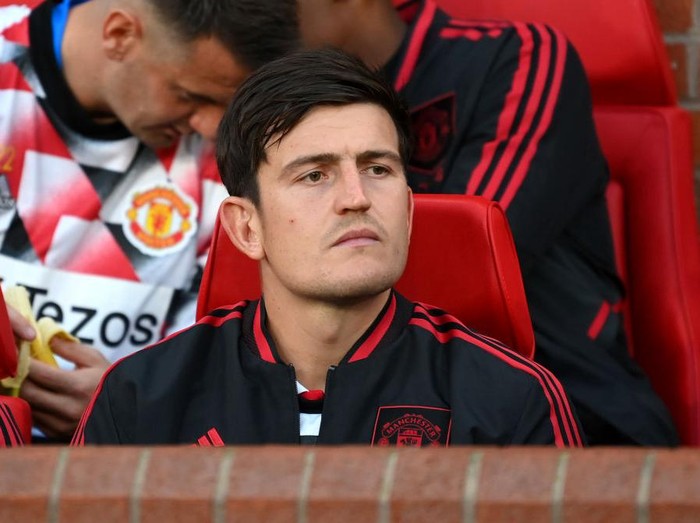 MANCHESTER, ENGLAND - AUGUST 22: Harry Maguire of Manchester United looks on from the substitutes bench prior to the Premier League match between Manchester United and Liverpool FC at Old Trafford on August 22, 2022 in Manchester, England. (Photo by Michael Regan/Getty Images)