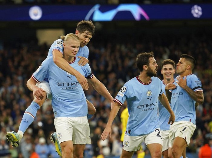 Manchester City's Erling Haaland, right on the pitch scores his side's 2nd goal during the group G Champions League soccer match between Manchester City and Borussia Dortmund at the Etihad stadium in Manchester, England, Wednesday, Sept. 14, 2022. (AP Photo/Dave Thompson)