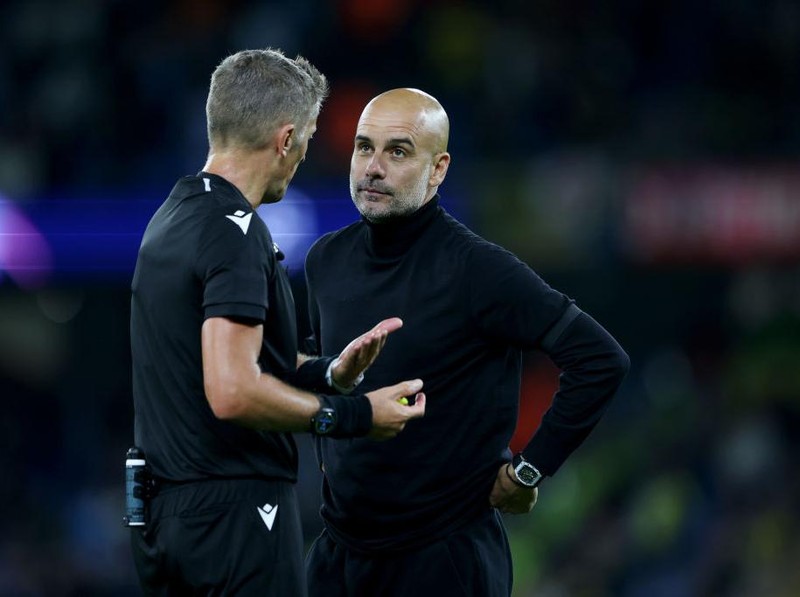 MANCHESTER, ENGLAND - SEPTEMBER 14: Pep Guardiola the head coach / manager of Manchester City reacts towards Match Referee Daniele Orsato of Italy which results in him receiving a yellow card at full time during the UEFA Champions League group G match between Manchester City and Borussia Dortmund at Etihad Stadium on September 14, 2022 in Manchester, United Kingdom. (Photo by Robbie Jay Barratt - AMA/Getty Images)
