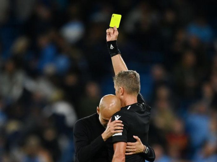 MANCHESTER, ENGLAND - SEPTEMBER 14: Pep Guardiola the head coach / manager of Manchester City reacts towards Match Referee Daniele Orsato of Italy which results in him receiving a yellow card at full time during the UEFA Champions League group G match between Manchester City and Borussia Dortmund at Etihad Stadium on September 14, 2022 in Manchester, United Kingdom. (Photo by Robbie Jay Barratt - AMA/Getty Images)