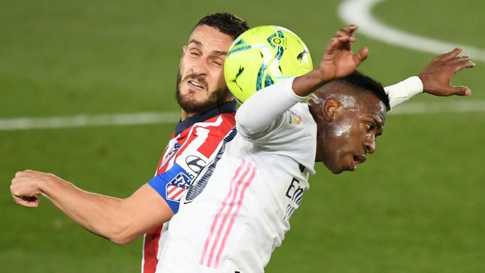 Atletico Madrids Spanish midfielder Koke (L) vies with Real Madrids Brazilian forward Vinicius Junior during the Spanish league football match between Real Madrid CF and Club Atletico de Madrid at the Alfredo di Stefano stadium in Madrid on December 12, 2020. (Photo by OSCAR DEL POZO / AFP) (Photo by OSCAR DEL POZO/AFP via Getty Images)