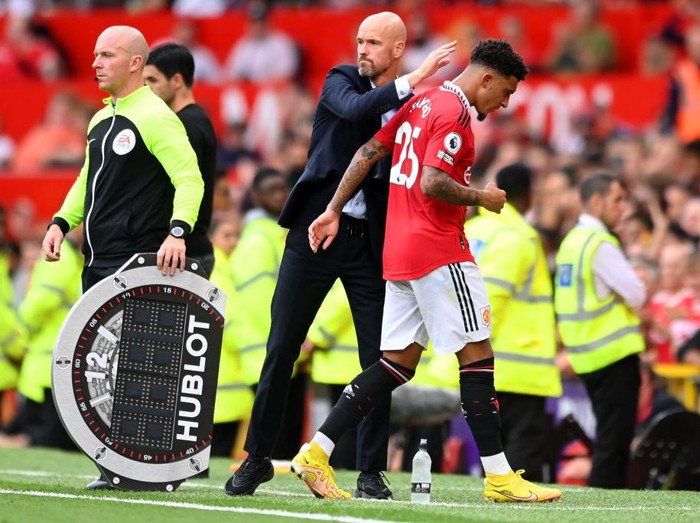 MANCHESTER, ENGLAND - SEPTEMBER 04: Erik ten Hag, Manager of Manchester United interacts with Jadon Sancho of Manchester United during the Premier League match between Manchester United and Arsenal FC at Old Trafford on September 04, 2022 in Manchester, England. (Photo by Michael Regan/Getty Images)