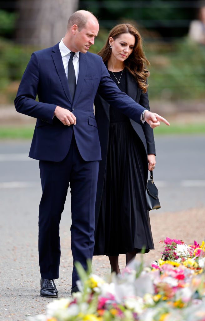 SANDRINGHAM, NORFOLK - SEPTEMBER 15: (EMBARGOED FOR PUBLICATION IN UK NEWSPAPERS UNTIL 24 HOURS AFTER CREATE DATE AND TIME) Prince William, Prince of Wales and Catherine, Princess of Wales view floral tributes left at the entrance to Sandringham House, the Norfolk estate of Queen Elizabeth II, on September 15, 2022 in Sandringham, England. The Prince and Princess of Wales are visiting Sandringham to view tributes to Queen Elizabeth II, who died at Balmoral Castle on September 8, 2022. (Photo by Max Mumby/Indigo/Getty Images)