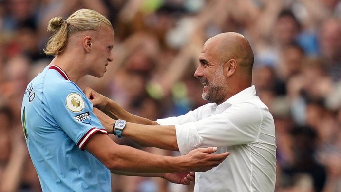 Manchester Citys Erling Haaland celebrates scoring his side fourth goal of the game to complete his hat trick with manager Pep Guardiola during the Premier League match at the Etihad Stadium, Manchester. Picture date: Saturday August 27, 2022. (Photo by Nick Potts/PA Images via Getty Images)