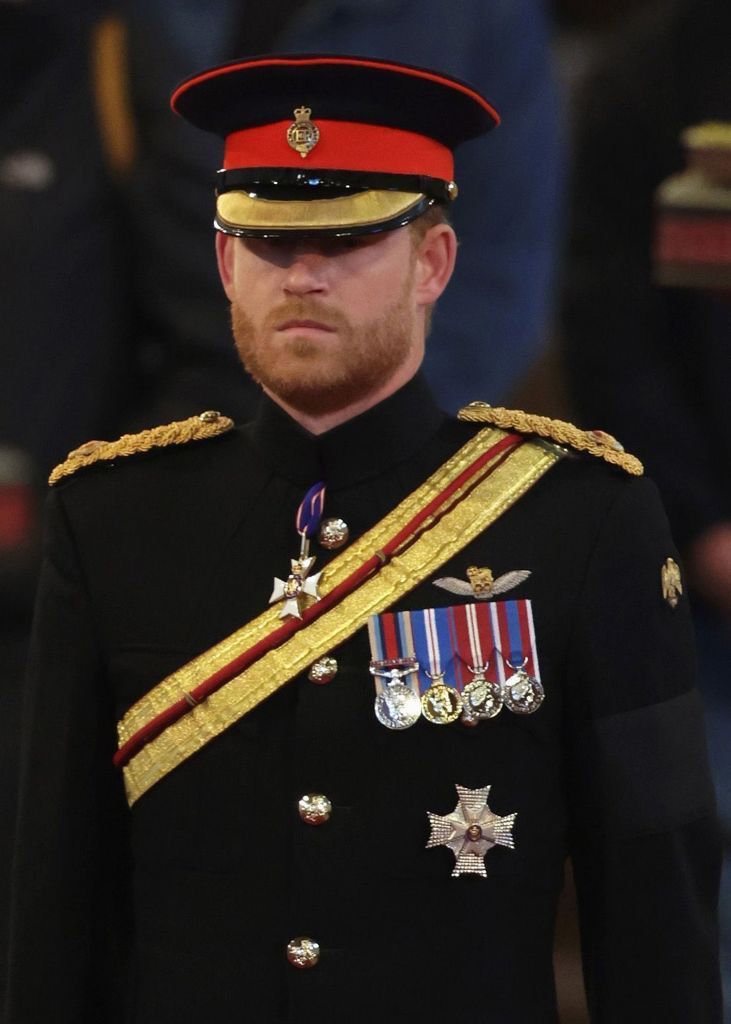 LONDON, ENGLAND - SEPTEMBER 17: Prince Harry, Duke of Sussex holds a vigil beside the coffin of their grandmother as it lies in state on the catafalque inside Westminster Hall on September 17, 2022 in London, England. Queen Elizabeth II's grandchildren mount a family vigil over her coffin lying in state in Westminster Hall. Queen Elizabeth II died at Balmoral Castle in Scotland on September 8, 2022, and is succeeded by her eldest son, King Charles III. (Photo by Aaron Chown - WPA Pool/Getty Images)