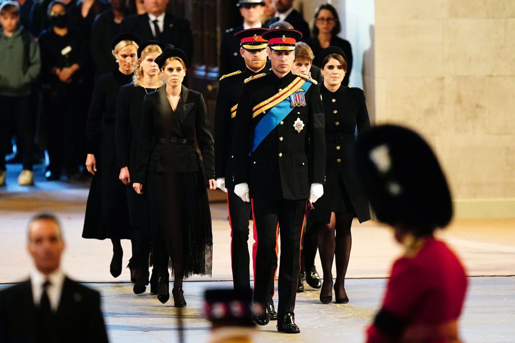 LONDON, ENGLAND - SEPTEMBER 17: Queen Elizabeth II 's grandchildren (L-R) Prince William, Prince of Wales, Princess Beatrice, Harry, Duke of Sussex and Peter Phillips hold a vigil beside the coffin of their grandmother as it lies in state on the catafalque inside Westminster Hall on September 17, 2022 in London, England. Queen Elizabeth II's grandchildren mount a family vigil over her coffin lying in state in Westminster Hall. Queen Elizabeth II died at Balmoral Castle in Scotland on September 8, 2022, and is succeeded by her eldest son, King Charles III. (Photo by Aaron Chown - WPA Pool/Getty Images)