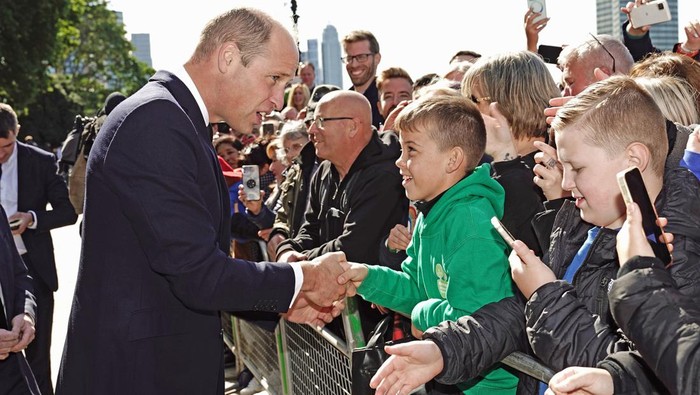 LONDON, UNITED KINGDOM - SEPTEMBER 17: Prince William, Prince of Wales meets members of the public in the queue along the South Bank, near to Lambeth Bridge, as they wait to view Queen Elizabeth II lying in state ahead of her funeral on Monday, on September 17, 2022 in London, United Kingdom. Queen Elizabeth II is lying in state at Westminster Hall until the morning of her funeral to allow members of the public to pay their last respects. Elizabeth Alexandra Mary Windsor was born in Bruton Street, Mayfair, London on 21 April 1926. She married Prince Philip in 1947 and acceded to the throne of the United Kingdom and Commonwealth on 6 February 1952 after the death of her Father, King George VI. Queen Elizabeth II died at Balmoral Castle in Scotland on September 8, 2022, and is succeeded by her eldest son, King Charles III. (Photo by Aaron Chown-WPA Pool/Getty Images)
