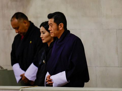 LONDON, ENGLAND - SEPTEMBER 18: Bhutan's King Jigme Khesar Namgyel Wangchuck and Queen Jetsun Pema gesture as they pay their respects  as they view the coffin of Queen Elizabeth II lying in state at Westminster Hall on September 18, 2022 in London, England. Members of the public are able to pay respects to Her Majesty Queen Elizabeth II for 23 hours a day from 17:00 on September 18, 2022 until 06:30 on September 19, 2022.  Queen Elizabeth II died at Balmoral Castle in Scotland on September 8, 2022, and is succeeded by her eldest son, King Charles III.(Photo by John Sibley-WPA Pool/Getty Images)