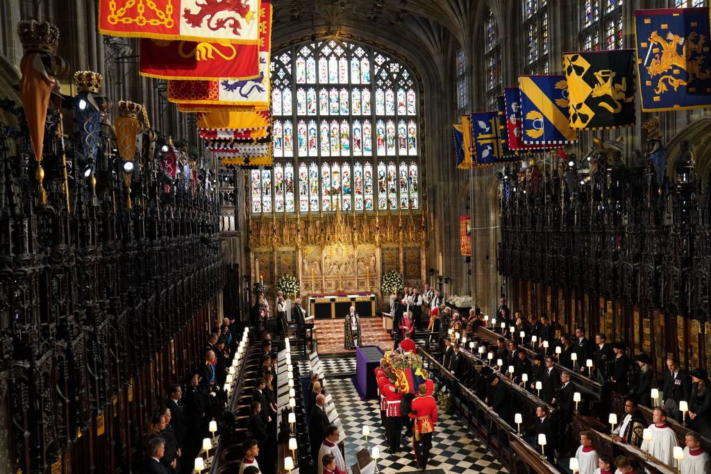 WINDSOR, ENGLAND - SEPTEMBER 19: The coffin of Queen Elizabeth II is carried by the Bearer Party in to the Committal Service at St George's Chapel in Windsor Castle on September 19, 2022 in Windsor, England. The committal service at St George's Chapel, Windsor Castle, took place following the state funeral at Westminster Abbey. A private burial in The King George VI Memorial Chapel followed. Queen Elizabeth II died at Balmoral Castle in Scotland on September 8, 2022, and is succeeded by her eldest son, King Charles III. (Photo by Joe Giddens - WPA Pool/Getty Images)
