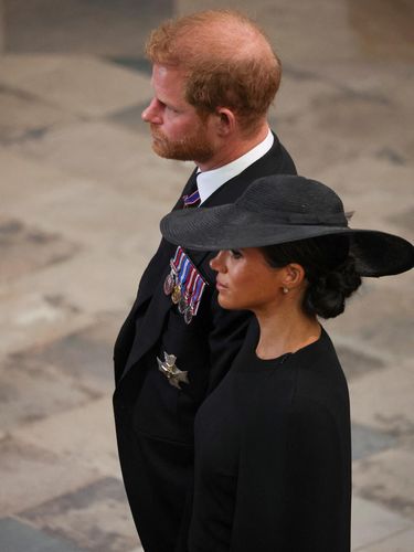 Britain's Prince Harry, Duke of Sussex (L) and Meghan, Duchess of Sussex (R) attend the State Funeral Service for Britain's Queen Elizabeth II at Westminster Abbey in London on September 19, 2022. (Photo by PHIL NOBLE / POOL / AFP)