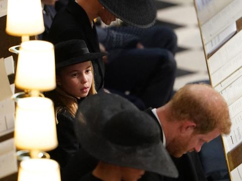 Britain's Princess Charlotte of Wales sits with Britain's Prince William, Prince of Wales, Britain's Prince George of Wales, Britain's Catherine, Princess of Wales, Britain's Prince Harry, Duke of Sussex and Meghan, Duchess of Sussex during the Committal Service for Britain's Queen Elizabeth II in St George's Chapel inside Windsor Castle on September 19, 2022. - Monday's committal service is expected to be attended by at least 800 people, most of whom will not have been at the earlier State Funeral at Westminster Abbey. (Photo by Joe Giddens / POOL / AFP)