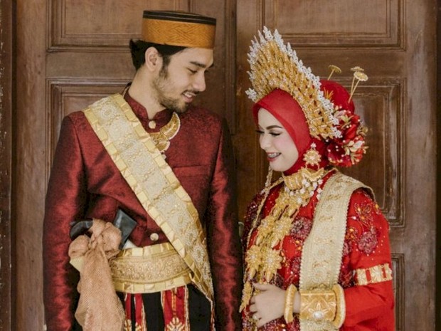 Pasangan Achmad Megantara dan Asri Faradila menggunakan pakaian adat Bugis bewarna merah sebagai baju pernikahannya/Foto: Instagram.com/maximuspictures