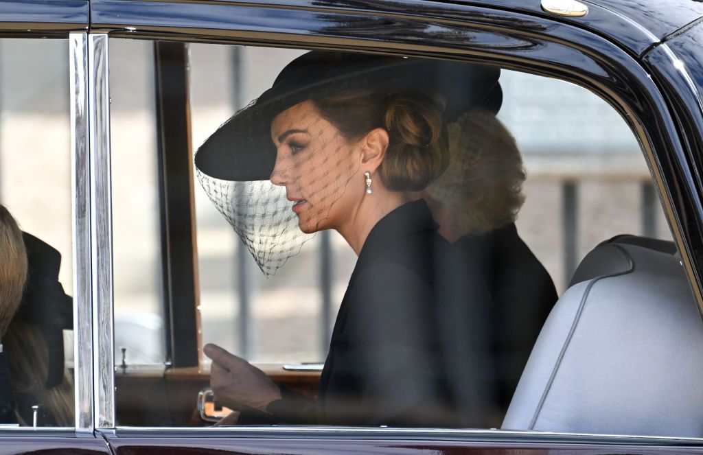 1243356712 LONDON, ENGLAND - SEPTEMBER 19: Catherine, Princess of Wales is seen in a car during the State Funeral of Queen Elizabeth II at Westminster Abbey on September 19, 2022 in London, England. Elizabeth Alexandra Mary Windsor was born in Bruton Street, Mayfair, London on 21 April 1926. She married Prince Philip in 1947 and ascended the throne of the United Kingdom and Commonwealth on 6 February 1952 after the death of her Father, King George VI. Queen Elizabeth II died at Balmoral Castle in Scotland on September 8, 2022, and is succeeded by her eldest son, King Charles III. (Photo by Sarah Meyssonnier - WPA Pool/Getty Images)