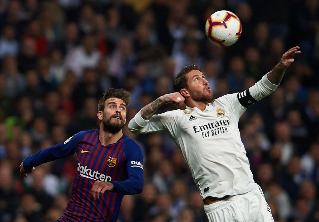 MADRID, SPAIN - MARCH 02: Sergio Ramos of Real Madrid competes for the ball with Gerard Pique of Barcelona during the La Liga match between Real Madrid CF and FC Barcelona at Estadio Santiago Bernabeu on March 02, 2019 in Madrid, Spain. (Photo by Quality Sport Images/Getty Images)