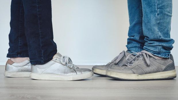 Two people wearing casual clothes standing close together. Concept: two lovers together or standing too close during coronavirus epidemic.