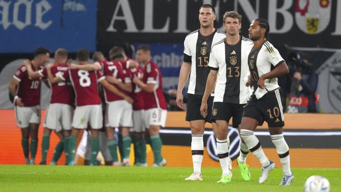 Germanys Serge Gnabry, right, Germanys Niklas Sule, and Germanys Thomas Muller react after Hungarys Adam Szalai scored his sides opening goal during the UEFA Nations League soccer match between Germany and Hungary at the Red Bull Arena in Leipzig, Germany, Friday, Sept. 23, 2022. (AP Photo/Michael Sohn)