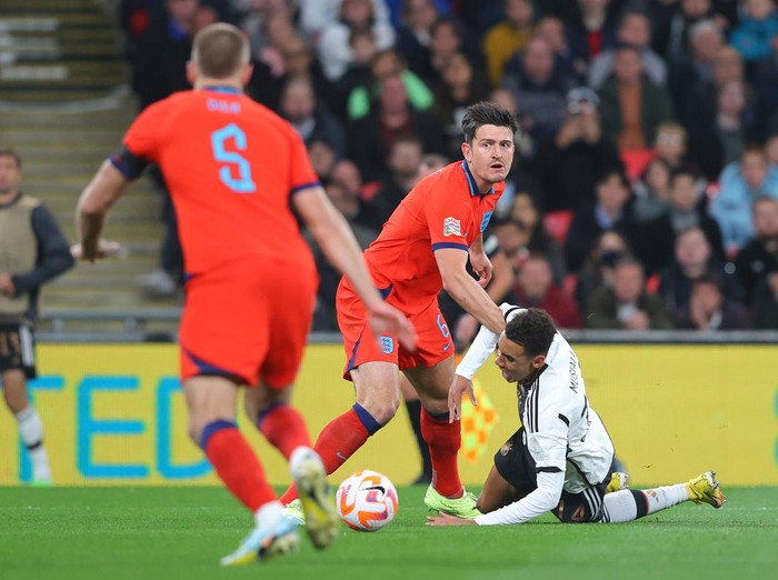 LONDON, ENGLAND - SEPTEMBER 26:  Harry Maguire of England fouls Jamal Musiala of Germany to concede a penalty during the UEFA Nations League League A Group 3 match between England and Germany at Wembley Stadium on September 26, 2022 in London, England. (Photo by James Gill - Danehouse/Getty Images)