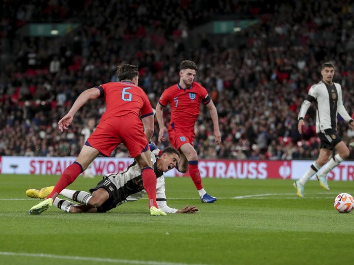 LONDON, ENGLAND - SEPTEMBER 26: Harry Maguire of England and Jamal Musiala of Germany battle for the ball during the UEFA Nations League League A Group 3 match between England and Germany at Wembley Stadium on September 26, 2022 in London, United Kingdom. (Photo by Michael Zemanek/DeFodi Images via Getty Images)