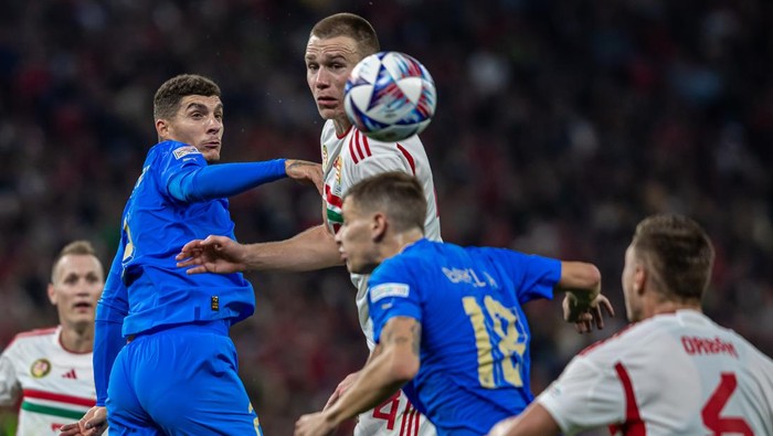 Attila Szalai of Hungary competes for the ball with Giovanni Di Lorenzo of Italy during the UEFA Nations League A3 match at Puskás Aréna on Sept 26, 2022 in Budapest, Hungary. (Photo by Robert Szaniszló/NurPhoto via Getty Images)