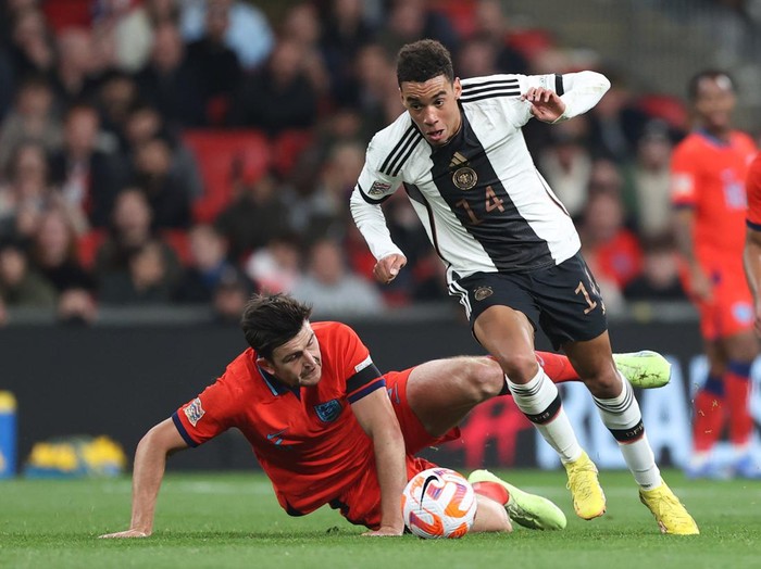 LONDON, ENGLAND - SEPTEMBER 26: Jamal Musiala of Germany avoids the tackle of Harry Maguire of England during the UEFA Nations League League A Group 3 match between England and Germany at Wembley Stadium on September 26, 2022 in London, United Kingdom. (Photo by Charlotte Wilson/Offside/Offside via Getty Images)