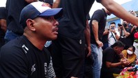 Mereka melakukan tabur bunga disertai doa bersama di patung Singa Tegar yang berada di luar stadion. Tangis pecah saat itu, hampir semua tak kuasa menahan air mata. (Dasril Roszandi/Getty Images)