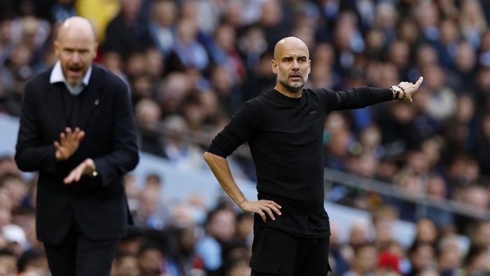 MANCHESTER, ENGLAND - OCTOBER 02: Pep Guardiola, Manager of Manchester City, reacts as Erik ten Hag, Manager of Manchester United looks on during the Premier League match between Manchester City and Manchester United at Etihad Stadium on October 02, 2022 in Manchester, England. (Photo by Lynne Cameron - Manchester City/Manchester City FC via Getty Images)