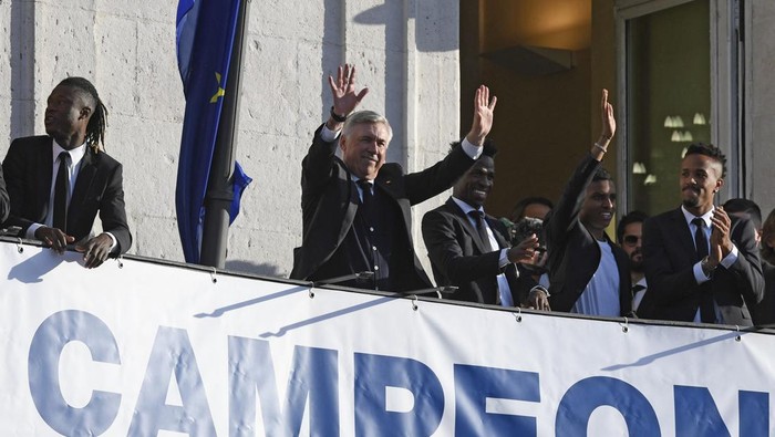 Real Madrids Italian coach Carlo Ancelotti (2L) waves as he celebrates with players at the regional government headquarters in Madrid on May 29, 2022, a day after beating Liverpool in the UEFA Champions League final in Paris. - Real Madrid claimed a 14th European Cup as Vinicius Juniors goal saw them beat Liverpool 1-0 in the Champions League final at the Stade de France amid chaotic scenes yesterday. (Photo by OSCAR DEL POZO / AFP) (Photo by OSCAR DEL POZO/AFP via Getty Images)