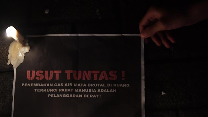 Suporter Arema FC (Aremania) meletakan poster ketika melakukan pertemuan di depan Stadion Gajyana, Kota Malang, Jawa Timur, Senin (3/10/2022). Dalam pertemuan tersebut mereka membahas mengenai gerakan aksi dan tuntutan agar tragedi Stadion Kanjuruhan diusut tuntas. ANTARA FOTO/Zabur Karuru/hp.