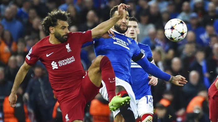 Liverpools Mohamed Salah, left, and Rangers Connor Goldson challenge for the ball during the Champions League Group A soccer match between Liverpool and Rangers at Anfield stadium in Liverpool, England, Tuesday Oct. 4, 2022. (AP Photo/Rui Vieira)