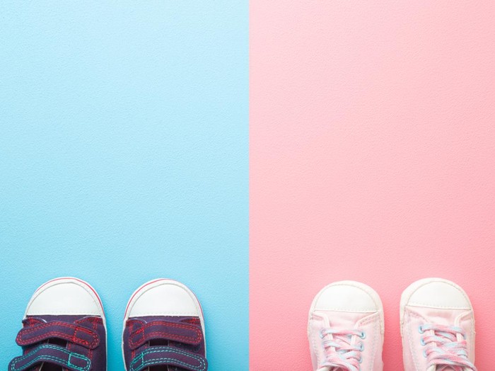 Ilustrasi Gender Netral Two pairs of sport shoes for little boys and girls. Pastel blue pink background. Baby footwear. Empty place for text. Top down view.