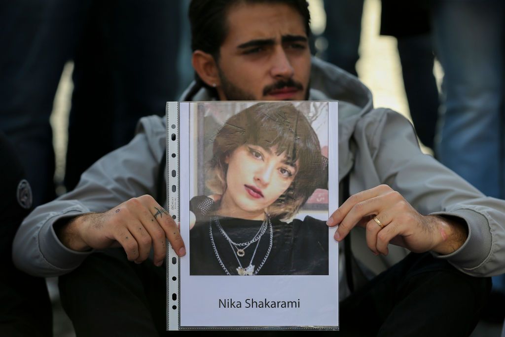 NAPLES, ITALY - 2022/10/06: A man with a photograph of Iranian woman Nika Shakarami, during the demonstration in Naples for the freedom of Iranian women, after the recent riots in Iran and the killing of Mahsa Amini. (Photo by Marco Cantile/LightRocket via Getty Images)