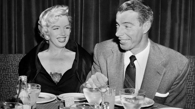 Picture dated of the fifties showing American actress Marilyn Monroe (L) with her husband baseball legend Joe DiMaggio. (Photo by AFP)