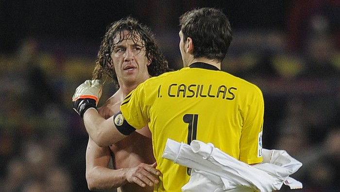 Real Madrids goalkeeper and captain Iker Casillas (R) greets Barcelonas captain Carles Puyol after the second leg of the Spanish Cup quarter-final 