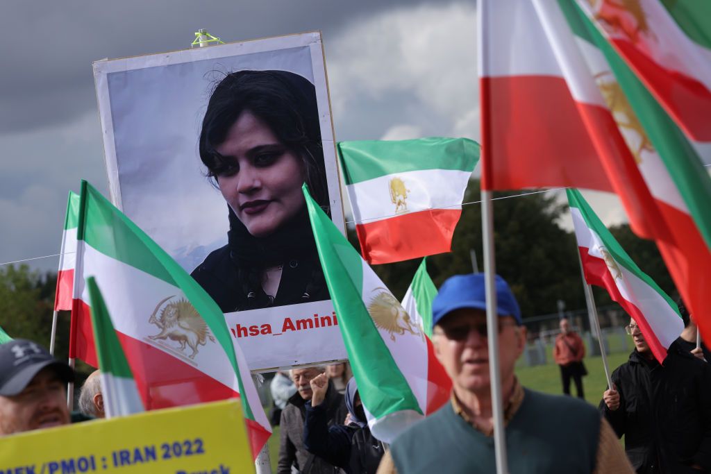 BERLIN, GERMANY - SEPTEMBER 28: Supporters of the National Council of Resistance of Iran, an Iranian opposition group based abroad, protest over the death of Mahsa Amini in Iran on September 28, 2022 in Berlin, Germany. Amini, 22, was arrested by Iranian authorities in Tehran on September 13 for not wearing her headscarf properly and died three days afterwards, apparently due to a severe head injury. Her death has sparked demonstrations in Iran nationwide that have spiralled into violence between protesters and police and left dozens of protesters dead. (Photo by Sean Gallup/Getty Images)