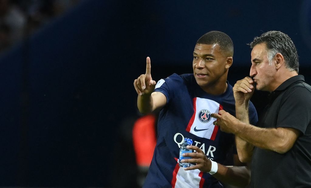 TOPSHOT - Paris Saint-Germain's French forward Kylian Mbappe (R) leaves the pitch after he is substituted by Paris Saint-Germain's French head coach Christophe Galtier (L) during the UEFA Champions League group H football match between Paris Saint-Germain (PSG) and SL Benfica, at The Parc des Princes Stadium, on October 11, 2022. (Photo by FRANCK FIFE / AFP) (Photo by FRANCK FIFE/AFP via Getty Images)