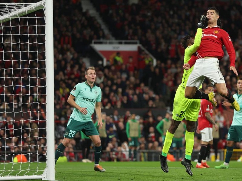 MANCHESTER, ENGLAND - OCTOBER 13: Francis Uzoho of Omonia Nikosia and Cristiano Ronaldo of Manchester United during the UEFA Europa League group E match between Manchester United and Omonia Nikosia at Old Trafford on October 13, 2022 in Manchester, United Kingdom. (Photo by Matthew Ashton - AMA/Getty Images)