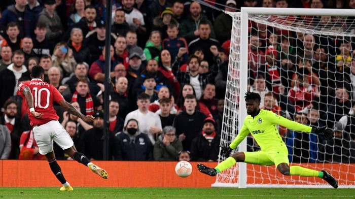 Omonias Nigerian goalkeeper Francis Uzoho (R) saves this shot from Manchester Uniteds English striker Marcus Rashford (L) during the UEFA Europa League Group E football match between Manchester United and Omonoia Nicosia, at Old Trafford stadium, in Manchester, north-west England, on October 13, 2022. (Photo by Oli SCARFF / AFP) (Photo by OLI SCARFF/AFP via Getty Images)