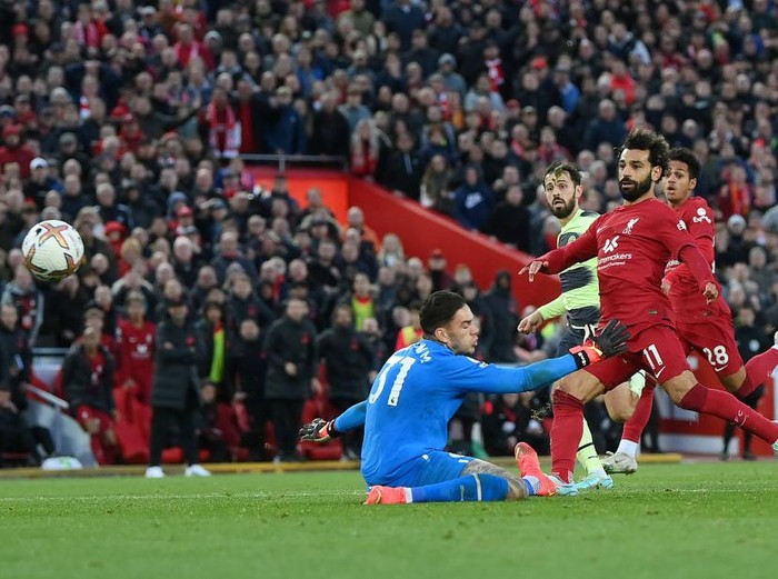 LIVERPOOL, ENGLAND - OCTOBER 16: Mohamed Salah of Liverpool scores their side's first goal past Ederson of Manchester City during the Premier League match between Liverpool FC and Manchester City at Anfield on October 16, 2022 in Liverpool, England. (Photo by Laurence Griffiths/Getty Images)
