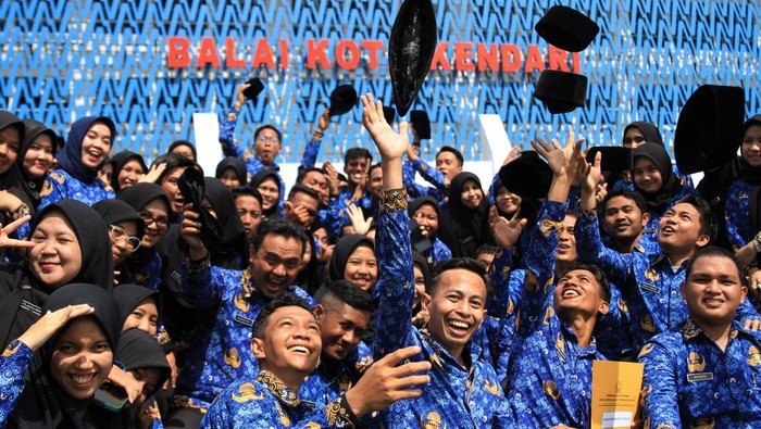 Senangnya Orang-orang Ini Diangkat Jadi PNS Sejumlah pegawai melempar peci usai disumpah menjadi PNS di Pemerintah Kota Kendari, Kendari, Sulawesi Tenggara, Senin (17/10/2022). Sebanyak 93 calon pegawai negeri sipil (CPNS) di lingkungan Pemerintah Kota Kendari diangkat dan diambil sumpah menjadi PNS. ANTARA FOTO/Jojon/aww.