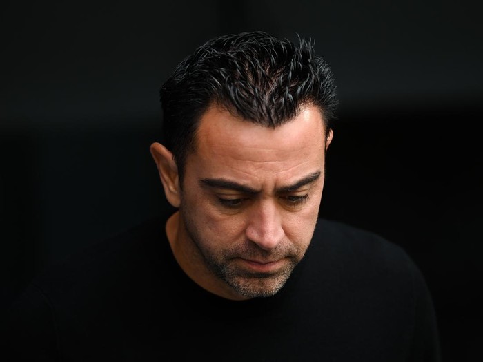 MADRID, SPAIN - OCTOBER 16: Head coach Xavi Hernandez of FC Barcelona looks down prior to the LaLiga Santander match between Real Madrid CF and FC Barcelona at Estadio Santiago Bernabeu on October 16, 2022 in Madrid, Spain. (Photo by David Ramos/Getty Images)