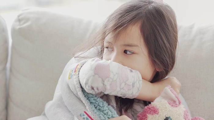 Ilustrasi Faktor ISPA pada Anak Mixed Asian sick girl coughing with her elbow at home, heath care concept