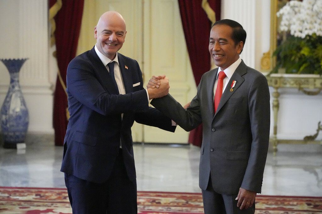 Indonesian President Joko Widodo, right, greets FIFA President Gianni Infantino during their meeting at Merdeka Palace in Jakarta, Indonesia, Tuesday, Oct. 18, 2022. (AP Photo/Achmad Ibrahim)